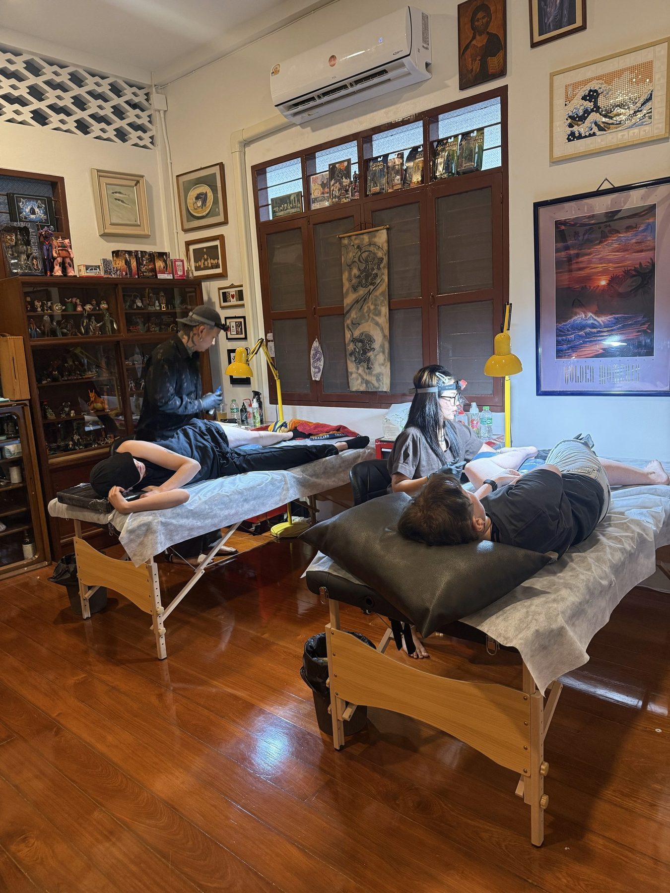 Tattoo artists working in Beach Street Arts studio atmosphere
